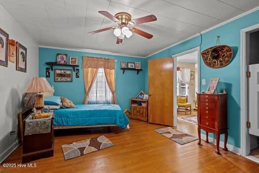 117 Arthur Rd, Beaufort, NC 28516 - bedroom with crown molding, wood finished floors, and a ceiling fan