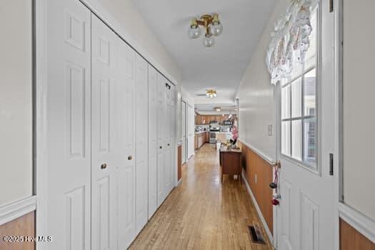 117 Arthur Rd, Beaufort, NC 28516 - hallway with light wood finished floors and wainscoting