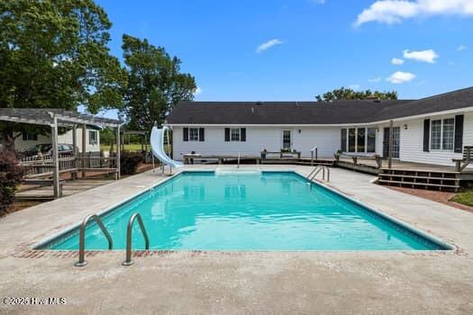 117 Arthur Rd, Beaufort, NC 28516 - swimming pool with a pergola, a water slide, and a deck