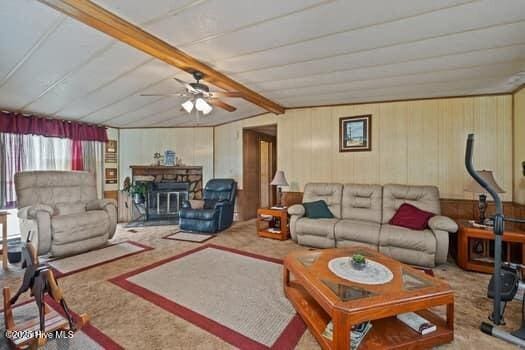 117 Arthur Rd, Beaufort, NC 28516 - carpeted living room featuring ceiling fan and wood walls