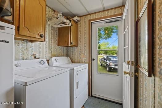 117 Arthur Rd, Beaufort, NC 28516 - washroom featuring independent washer and dryer, cabinet space, wallpapered walls, and water heater