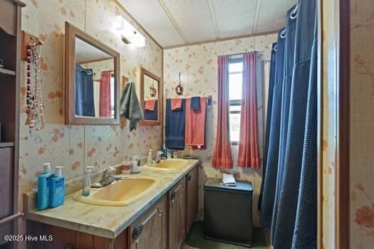 117 Arthur Rd, Beaufort, NC 28516 - bathroom featuring wallpapered walls and double vanity