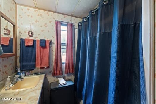 117 Arthur Rd, Beaufort, NC 28516 - full bathroom with wallpapered walls, vanity, and a shower with curtain