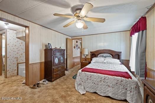 117 Arthur Rd, Beaufort, NC 28516 - carpeted bedroom featuring wood walls and a ceiling fan