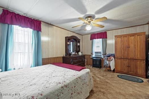 117 Arthur Rd, Beaufort, NC 28516 - bedroom featuring carpet flooring, wood walls, and ceiling fan