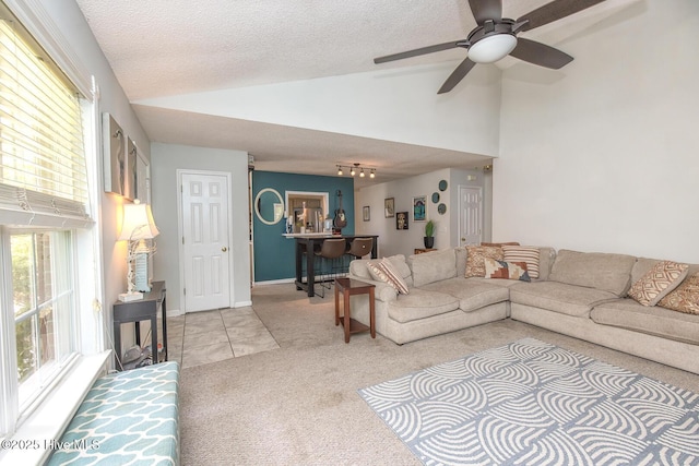 1009 Steeplechase Rd, Wilmington, NC 28412 - living room featuring light colored carpet, vaulted ceiling, a textured ceiling, ceiling fan, and healthy amount of natural light