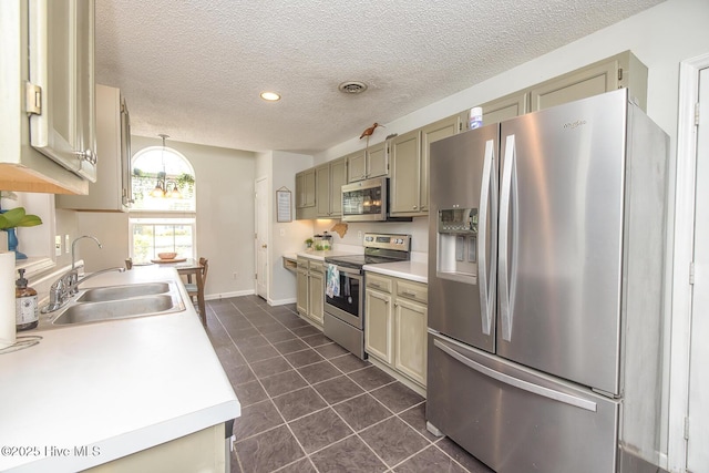 1009 Steeplechase Rd, Wilmington, NC 28412 - kitchen featuring appliances with stainless steel finishes, a sink, dark tile patterned flooring, a textured ceiling, and light countertops