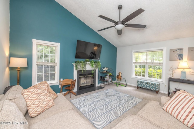 1009 Steeplechase Rd, Wilmington, NC 28412 - carpeted living room with ceiling fan, healthy amount of natural light, baseboards, a fireplace with flush hearth, and a textured ceiling
