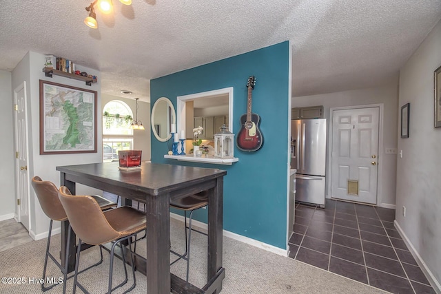 1009 Steeplechase Rd, Wilmington, NC 28412 - dining room featuring a textured ceiling and baseboards
