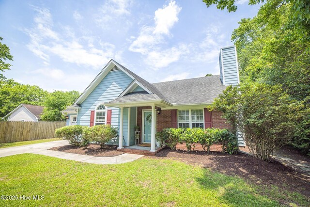 1009 Steeplechase Rd, Wilmington, NC 28412 - view of front of home with a chimney, a shingled roof, and brick siding
