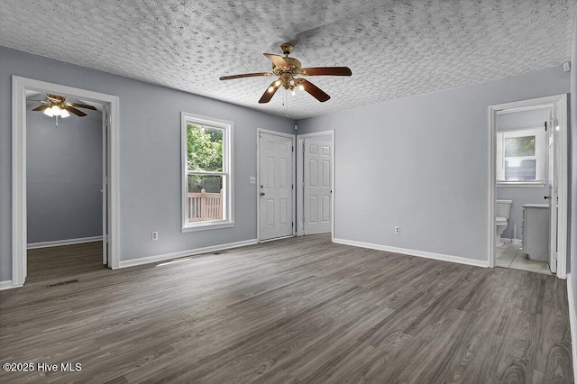 1912 Nun St, Wilmington, NC 28403 - unfurnished bedroom with dark wood-type flooring and baseboards