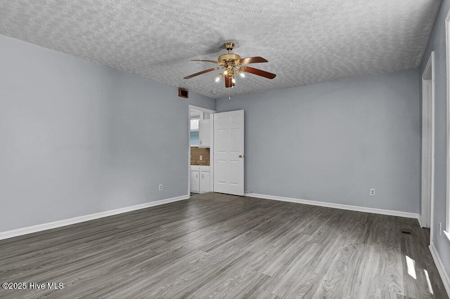 1912 Nun St, Wilmington, NC 28403 - unfurnished room with ceiling fan, wood finished floors, baseboards, and a textured ceiling