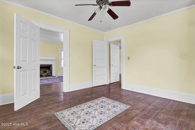 1912 Nun St, Wilmington, NC 28403 - spare room featuring ceiling fan, hardwood / wood-style floors, ornamental molding, baseboards, and a brick fireplace