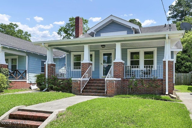1912 Nun St, Wilmington, NC 28403 - view of front of house with a chimney, a porch, and brick siding