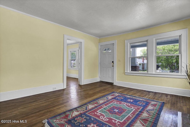 1912 Nun St, Wilmington, NC 28403 - foyer with a textured ceiling, crown molding, dark wood finished floors, and baseboards