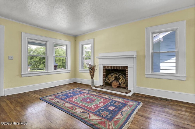 1912 Nun St, Wilmington, NC 28403 - living area with wood finished floors, crown molding, a brick fireplace, baseboards, and a textured ceiling