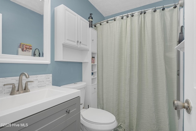 4602 Song Sparrow Ct, Wilmington, NC 28412 - bathroom with toilet, backsplash, vanity, a textured ceiling, and a shower with curtain