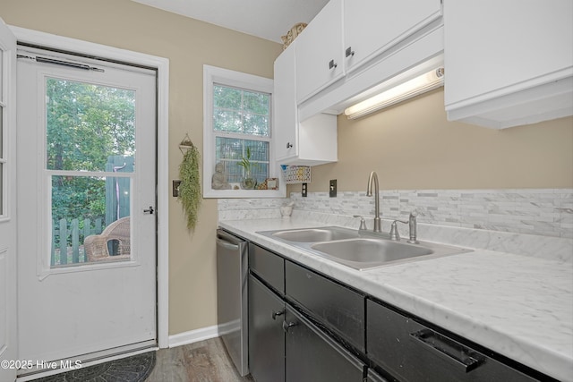 4602 Song Sparrow Ct, Wilmington, NC 28412 - kitchen featuring dishwasher, white cabinets, a sink, light countertops, and wood finished floors