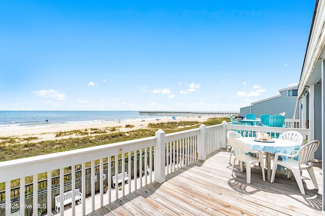 28 E First St Unit 4B, Ocean Isle Beach, NC 28469 - wooden deck with outdoor dining space and view of water and beach
