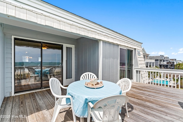 28 E First St Unit 4B, Ocean Isle Beach, NC 28469 - wooden deck featuring outdoor dining area