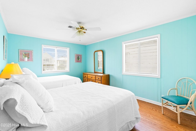 28 E First St Unit 4B, Ocean Isle Beach, NC 28469 - bedroom with wood finished floors, baseboards, ornamental molding, and a ceiling fan