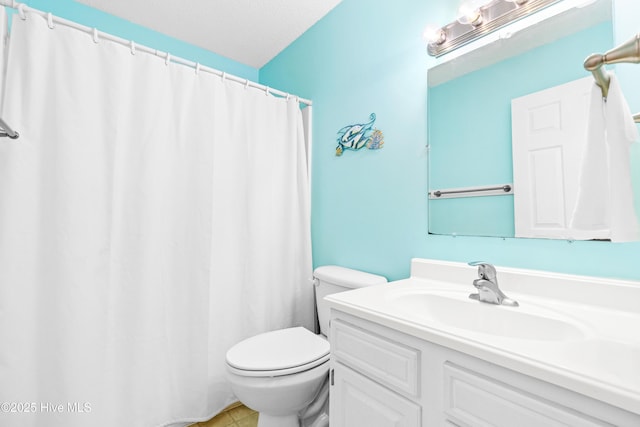 28 E First St Unit 4B, Ocean Isle Beach, NC 28469 - bathroom featuring toilet, vanity, tile patterned flooring, and a shower with curtain