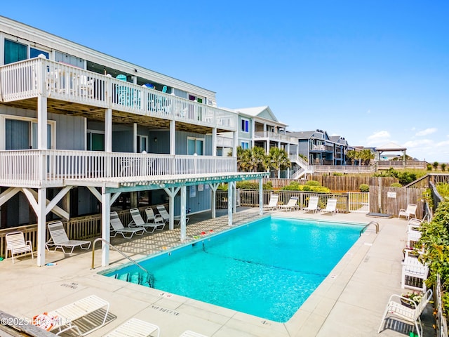 28 E First St Unit 4B, Ocean Isle Beach, NC 28469 - community pool featuring fence, a patio, and a residential view