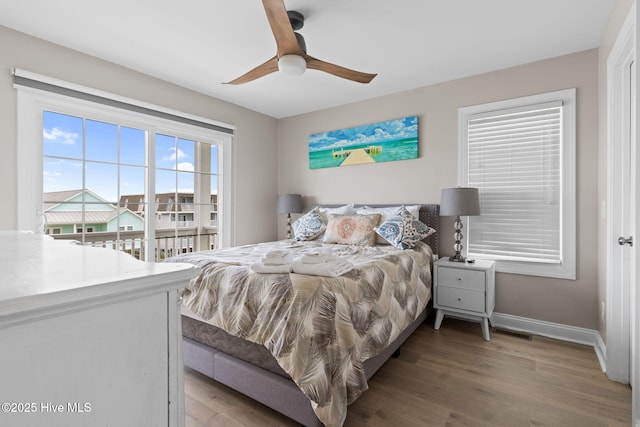 2721 W Beach Dr, Oak Island, NC 28465 - bedroom featuring wood finished floors, baseboards, and ceiling fan