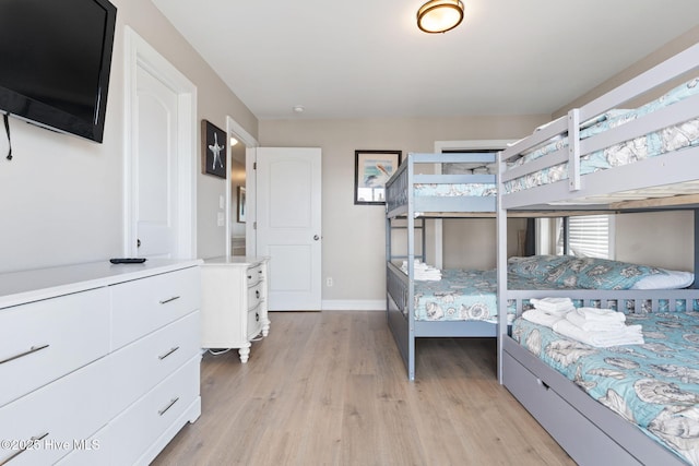 2721 W Beach Dr, Oak Island, NC 28465 - bedroom with light wood-style flooring and baseboards