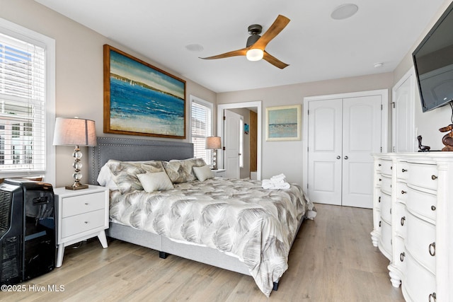 2721 W Beach Dr, Oak Island, NC 28465 - bedroom featuring multiple windows, light wood-style floors, a closet, and ceiling fan