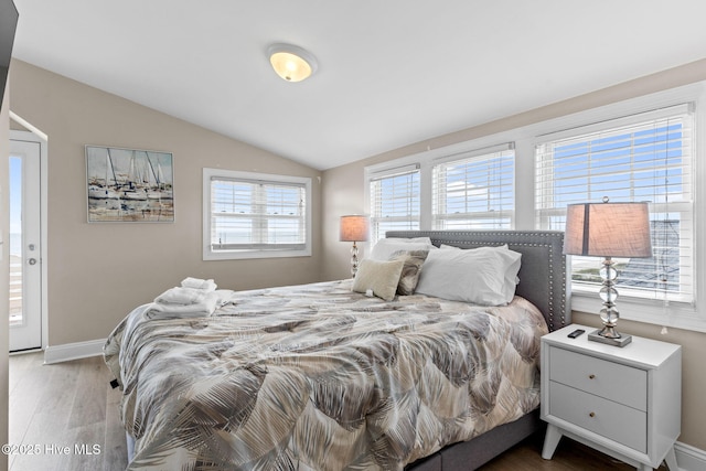 2721 W Beach Dr, Oak Island, NC 28465 - bedroom featuring wood finished floors, vaulted ceiling, and baseboards