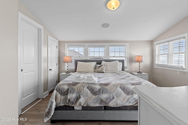 2721 W Beach Dr, Oak Island, NC 28465 - bedroom featuring lofted ceiling and wood finished floors