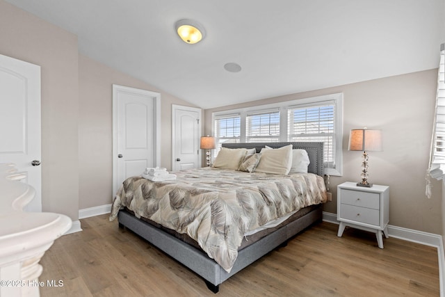 2721 W Beach Dr, Oak Island, NC 28465 - bedroom featuring baseboards, light wood finished floors, and vaulted ceiling