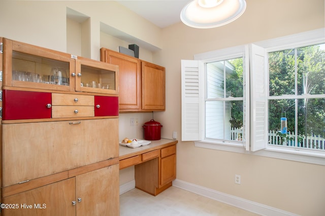 102 Macgregor Dr, Beaufort, NC 28516 - kitchen featuring baseboards, glass insert cabinets, light flooring, and light countertops