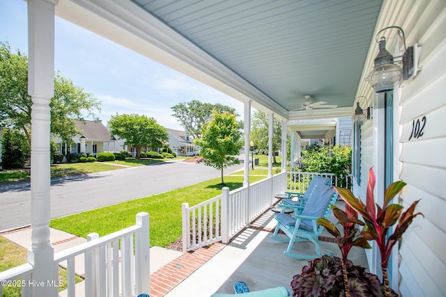 102 Macgregor Dr, Beaufort, NC 28516 - porch with a ceiling fan, a residential view, and a lawn