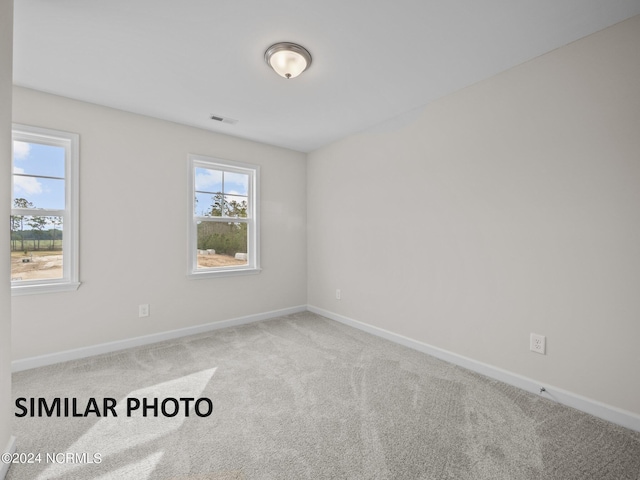 unfurnished room featuring carpet flooring and baseboards
