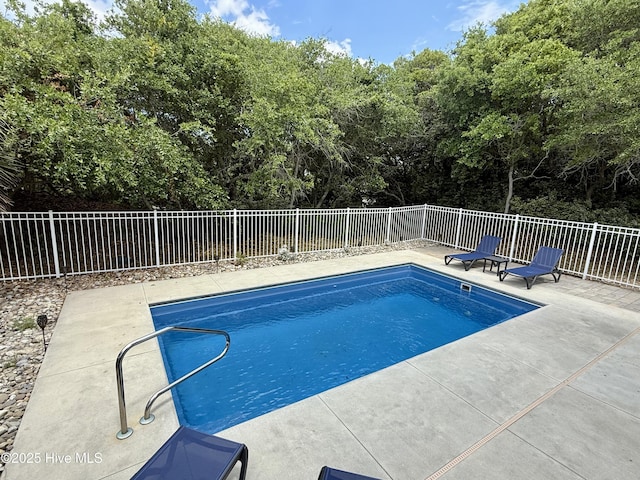 view of swimming pool with a fenced backyard and a patio