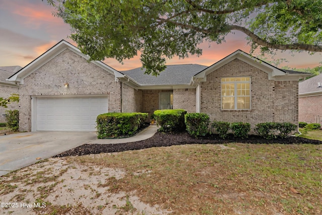 417 Settlers Ln, Kure Beach, NC 28449 - ranch-style home featuring an attached garage, driveway, brick siding, and a shingled roof