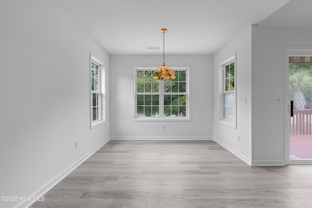 417 Settlers Ln, Kure Beach, NC 28449 - unfurnished dining area with plenty of natural light, light wood-style floors, and baseboards