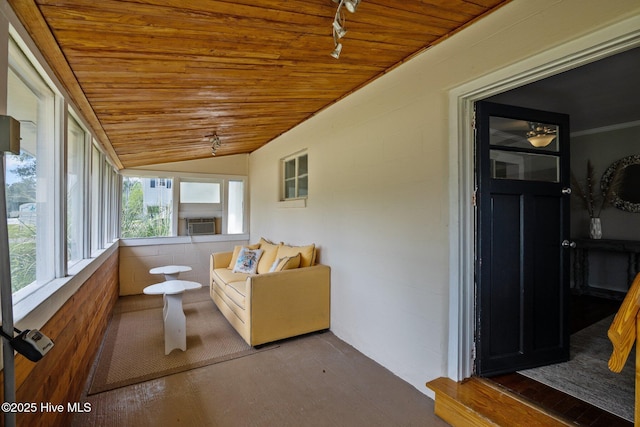 sunroom with wood ceiling, vaulted ceiling, wood finished floors, cooling unit, and track lighting