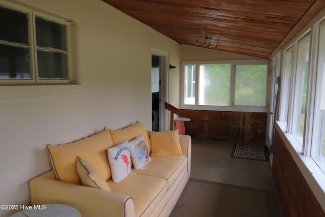 sunroom featuring wood ceiling, vaulted ceiling, and carpet