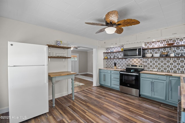 kitchen featuring open shelves, stainless steel appliances, wooden counters, and blue cabinetry