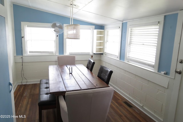 dining room featuring vaulted ceiling and wood finished floors