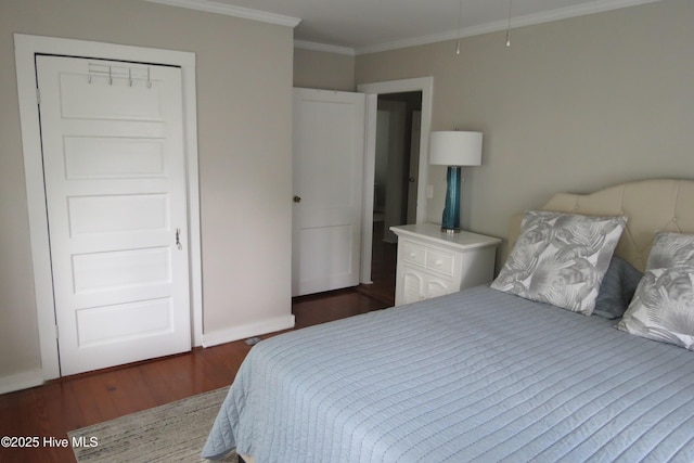 bedroom with wood finished floors, crown molding, and baseboards