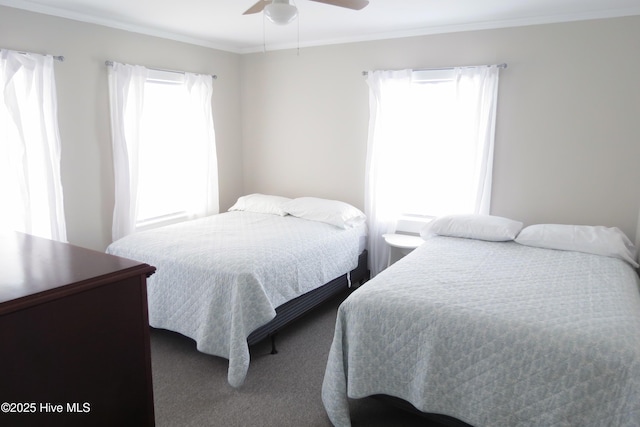 bedroom with carpet flooring, ornamental molding, and ceiling fan