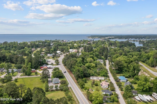 aerial overview of property's location with a large body of water and a tree filled landscape