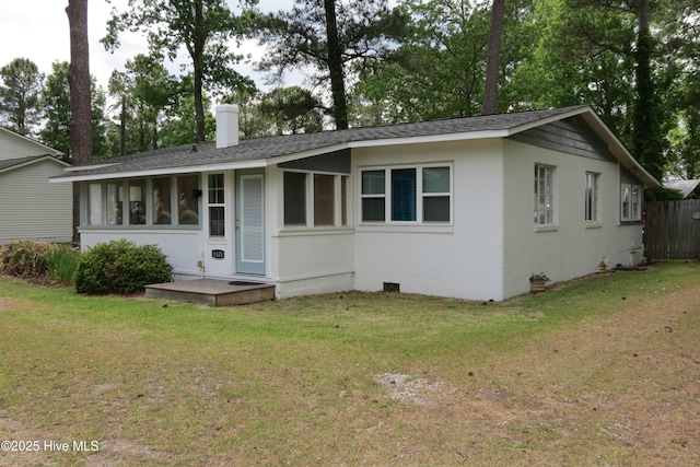 view of front facade with roof with shingles, crawl space, and a chimney