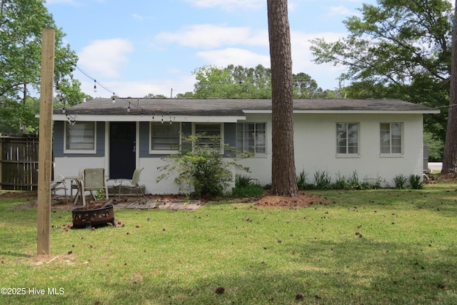 view of front of house with an outdoor fire pit and stucco siding