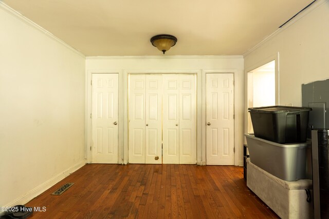 705 Dennis Rd, Jacksonville, NC 28546 - unfurnished bedroom with dark wood-style flooring, crown molding, and baseboards