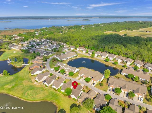 aerial overview of property's location with nearby suburban area, a nearby body of water, and a golf course
